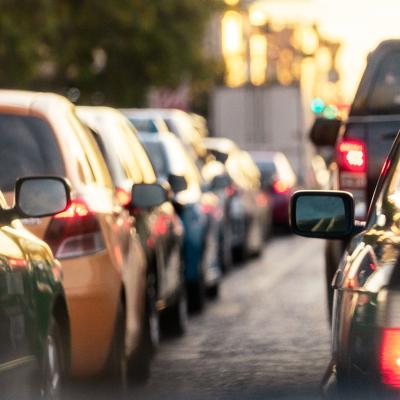 A lane of cars on the road during rush hour.