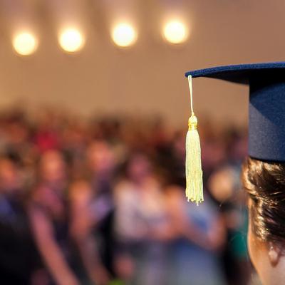 A graduating student facing the ceremony crowd.