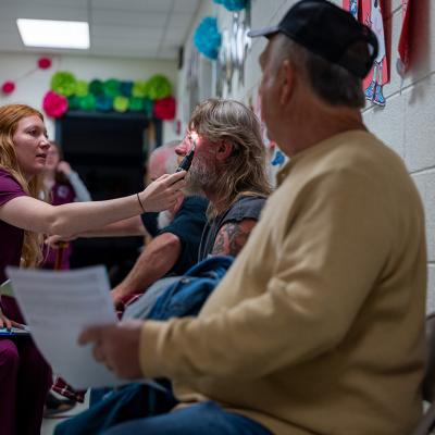  Optometry students administer vision tests to patients at a mobile dental and medical clinic in Grundy, Virginia.