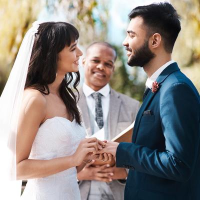 Happy couple exchanging vows during their wedding ceremony.