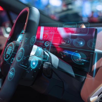 Close-up of a futuristic car dashboard featuring a digital interface with holographic displays and advanced controls.