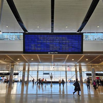 View of the Parallel Reality Experience, a personalized large screen monitor with flight information for Skymiles members at the Salt Lake City Airport.