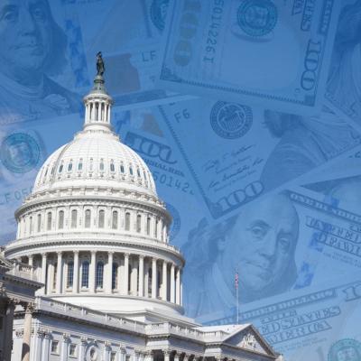 Cutout of U.S. capitol with 100 dollar banknotes layered over the blue sky.