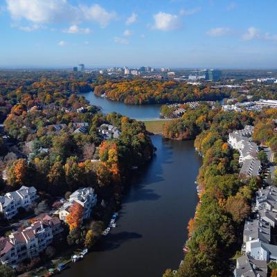 Aerial view of colorful fall trees surround lakes and homes in Fairfax County, Virginia. 