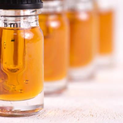 Macro detail of dropper with CBD oil, cannabis live resin extraction isolated on white background.