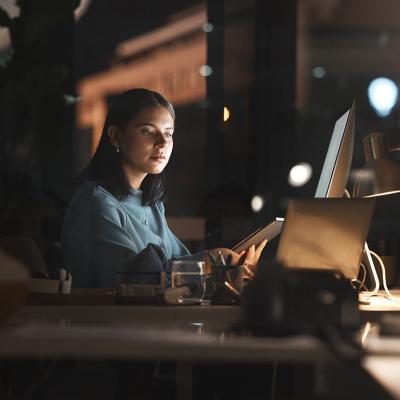 A businesswoman working in office at night.