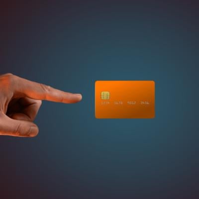 A hand levitating a credit card.