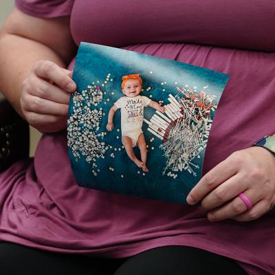Elizabeth Goldman, an in-vitro fertilization patient at the University of Alabama at Birmingham, holds up a photo of her daughter who was born via the procedure.