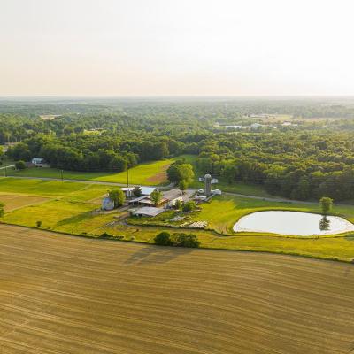 An aerial view of a small farm in southern Indiana during golden hour on a sunny summer day.