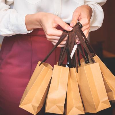 Employee holding corporate gift bag packages.