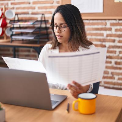 A female business worker looking at business documents.