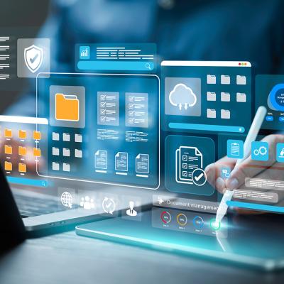 Employee working on a laptop with holographic illustrations of document management software concepts.