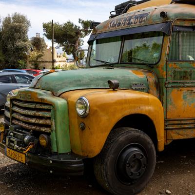 A vintage, old-timer school bus repurposed as a camper van.