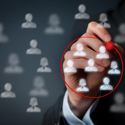 A hand encircling a group of business people graphic figures with a red marker.