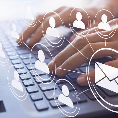 Hands typing on a keyboard illustrated with email and figure icons.