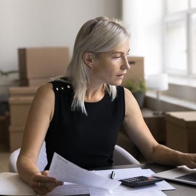 A female business owner reviewing documents in her office.