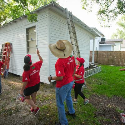 Volunteers from CITGO paint a home as part of a repairs initiative in Houston, Texas.