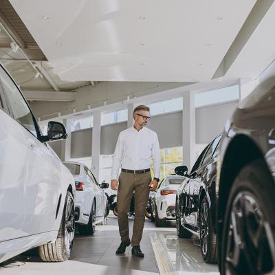 Man looking around a car dealership.