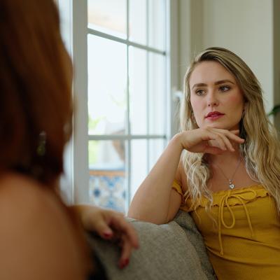 A woman talking to her friend at home.