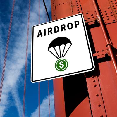 Signage showing "Airdrop" with a symbol of a cryptocurrency token attached to a parachute.