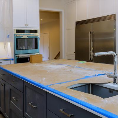 A modern kitchen with a focus on a countertop in progress of renovation.