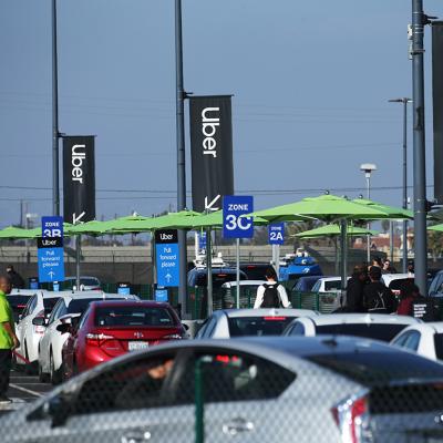 Uber vehicles lined up at the new 'LAX-it' ride-hail passenger pickup lot at Los Angeles International Airport (LAX), California.