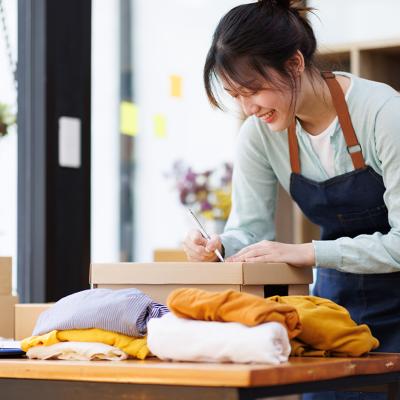 A young female small business owner preparing an order for packaging.