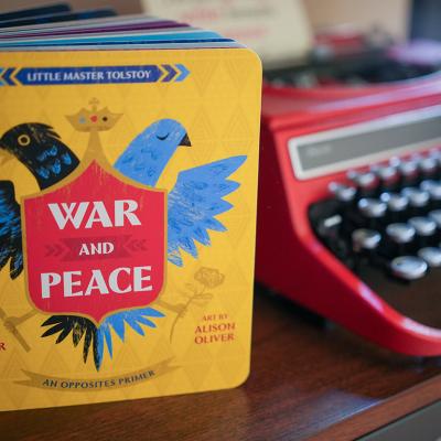 A version of Tolstoy's 'War and Peace' by Jennifer Adams as a children's book, beside a typewriter.