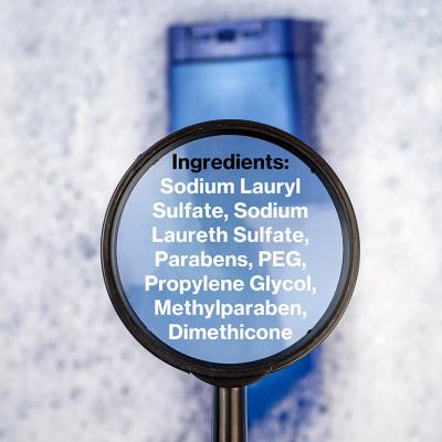 Chemical components listed on a magnifying glass over a shampoo bottle.