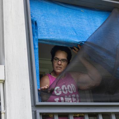 Kristi Naquin shows wind-damaged screens at her 3-year-old home which she says are substandard. They were built as part of the first federally funded relocation project in the United States.