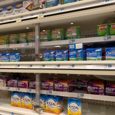 Xyzal and Zyrtec inside a pharmacy shelf with other allergy and sinus products.