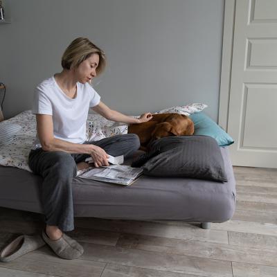 Single middle-aged woman looking at a pile of bills.
