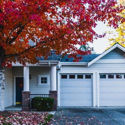 The front of a modern residential home during fall time.