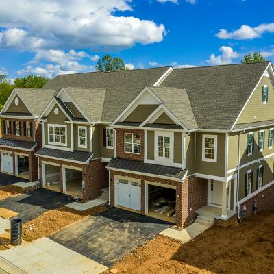 A large, modern triplex home nearing completion.