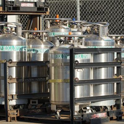  Industrial Oxygen cylinders waiting in racks outside filled and waiting to be put into use in Watsonville , California.