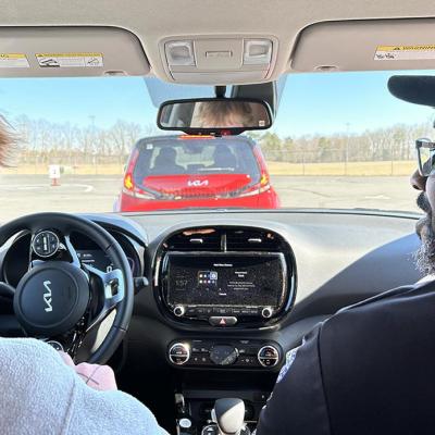 View from backseat of teen driver and expert behind the wheel. 