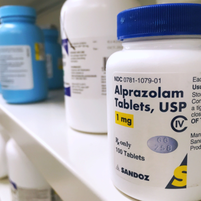 Xanax bottle on shelf.