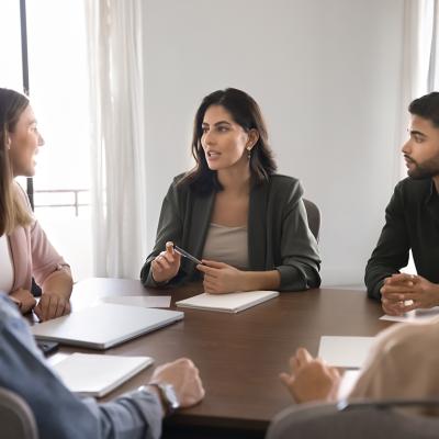 A business team seated around a conference table.