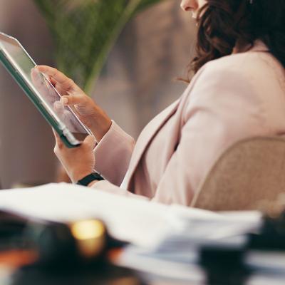 A female lawyer using a tablet in her home office.