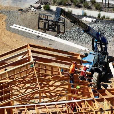 Aerial view of a home under construction with workers present on site in San Rafael, California.
