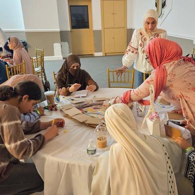 Women and girls of all ages gather for Sisters Self-Care Night at Muslim American Society Youth Center in Brooklyn, New York, a vibrant recurring event where creative activities and candid conversations help de-stigmatize seeking mental health support and weave faith and mental wellness together in community. 