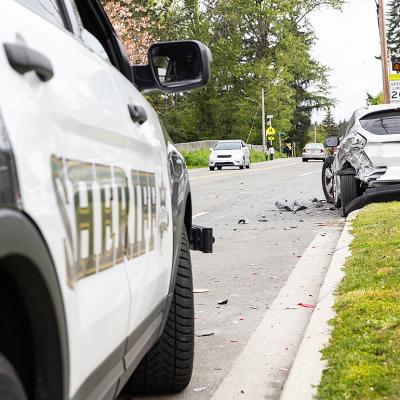 A car crash on the side of a street from the point of view of a sheriff's car.