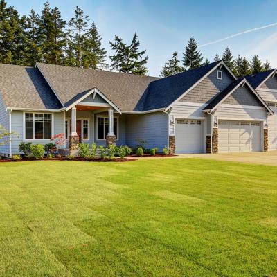 A modern, luxury home with a wide lawn in a Northwestern residential neighborhood in the US.