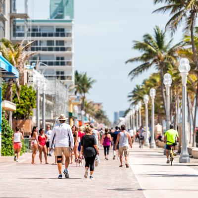 People along the beach boardwalk in Miami, Florida.