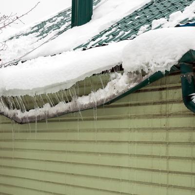 Heavy snow destroys as it accumulated on a home's drainage system.