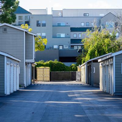 Symmetrical view of urban apartments' garages in a paved driveway.