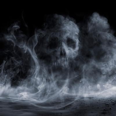 Fog forming a figure of a skull on dark background.