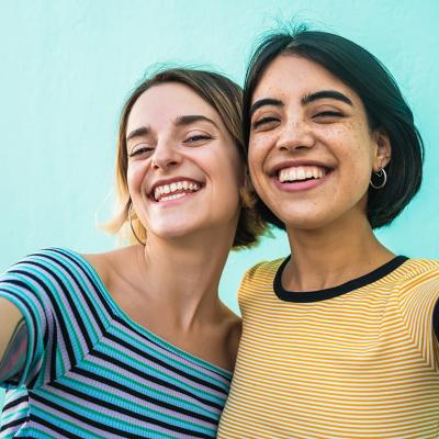 Two young women smiling for a selfie-style photograph.