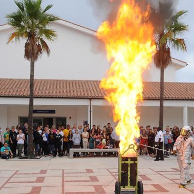 Personnel assigned to the Naval Station Rota Fire Department demonstrate the consequences of putting water on a grease fire to students at David G. Farragut Middle/High School.