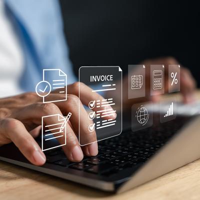 Business expense software concept using invoice graphics illustrated over a person using a laptop.
